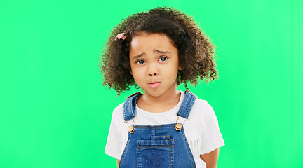 Image showing Sad, unhappy and face of a child on a green screen isolated on a studio background. Trouble, crying and portrait of a girl kid on a backdrop with sadness, expression and emotion with mockup space