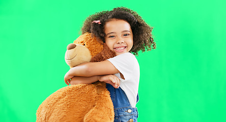 Image showing Happy, little girl and hugging teddy bear on green screen of cute innocent child isolated against studio background. Portrait of adorable kid smile with soft toy hug for childhood on chromakey mockup