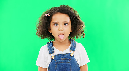 Image showing Little girl, silly and goofy face on green screen with facial expressions against a studio background. Portrait of female child or kid making funny faces with tongue out for childhood youth on mockup