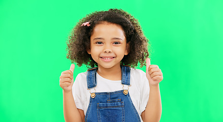 Image showing Cute, green screen and face of a child with a thumbs up isolated on a studio background. Winning, success and portrait of a girl kid with an emoji hand gesture for motivation, yes and agreement