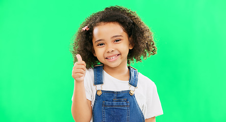 Image showing Happy, green screen and face of a child with a thumbs up isolated on a studio background. Winning, success and portrait of a girl kid with an emoji hand gesture for motivation, yes and agreement