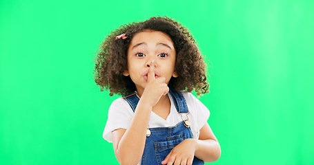 Image showing Face, green screen and child with finger on lips for quiet, silence or shush gesture on studio background. Noise, whisper and girl portrait with secret, emoji and hand symbol while posing isolated