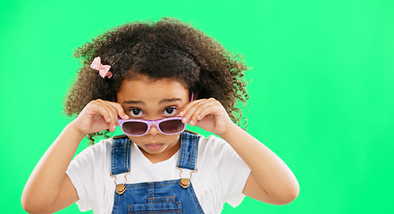 Image showing Portrait, green screen and a girl looking over her glasses in studio to ask a question with attitude. Kids, fashion and eyewear with an adorable little female child on chromakey mockup for style