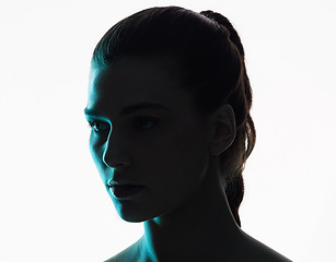 Image showing Beauty, woman and neon shadow light with dark lighting or posing in studio or skincare glow. Aesthetic, creativity and silhouette or face of a young model with blue color design on background