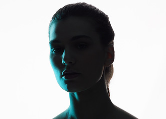 Image showing Silhouette, portrait and woman in neon shadow with dark lighting or posing in studio in futuristic glow and isolated in studio. Aesthetic, creativity and face model in blue color design on background