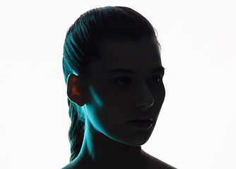 Image showing Beauty, neon and silhouette with face of woman in studio for creative, glow or lighting mockup space. Fantasy, shadow and shine with female model on white background for art, disco and dark aesthetic