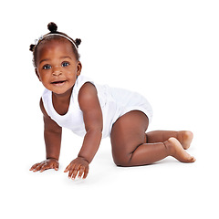 Image showing Smile, portrait and African girl baby isolated on white background with playful happiness, crawling and growth. Learning to crawl, play and development, happy face of black child on studio backdrop.