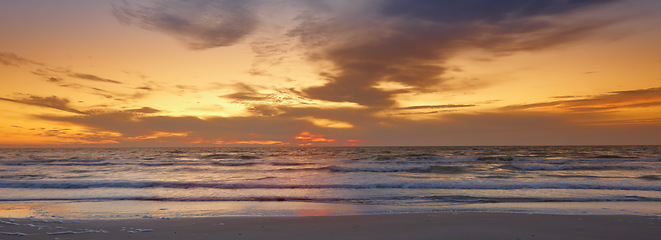 Image showing Sky, sunset and sea at morning on the horizon with ocean and waves landscape. Sunrise, calm weather and summer by the beach with coastline and outdoor with the sun setting by water in nature