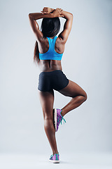 Image showing Black woman, strong muscle and body with back in studio for balance, pose or training by white background. Isolated girl, model and bodybuilder for healthy workout with development, exercise or flex