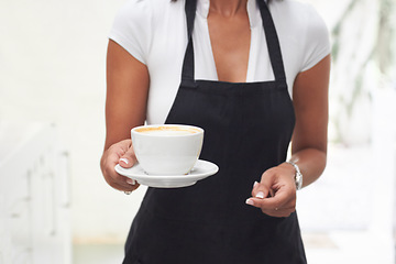 Image showing Coffee cup, giving and woman hands for restaurant service, hospitality and customer experience. Latte, drink or espresso with waitress or person in cafe closeup for industry, business or shop barista