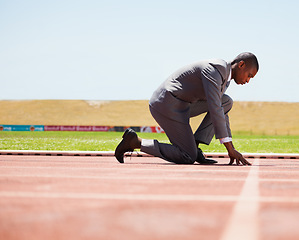 Image showing Start, race track and man in a suit for sport, running and fitness, cardio and speed practice. Starting line, ready and formal male sports runner at a stadium for challenge, performance and workout