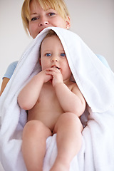 Image showing Baby, towel and portrait with care for mother with comfort or love in a closeup or family home. Mom, hug and holding an infant for bath with cleaning or affection at house for hygiene with happy kid.