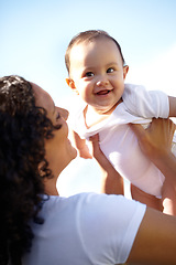 Image showing Family, mother and baby outdoor in summer on a blue sky background with a mother lifting her infant daughter for flying. Love, kids and a mom holding her female child while bonding together in summer