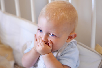 Image showing Happy, face and toddler standing in crib, bedroom or excited baby boy with hands on teething mouth for morning surprise of mistake. Kid sitting in cot, awake and healthy bed routine for young child