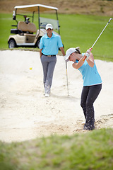 Image showing Golf course, sports and woman golfer playing sport for fitness, workout and exercise with a swing on a sand. Wellness, person and athlete training in action or outdoor game with a club stroke