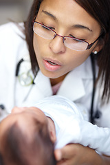 Image showing Healthcare, medicine and a pediatrician with a baby in the hospital for insurance, care or treatment. Medical, kids and a doctor woman holding a newborn infant in a health clinic for an appointment