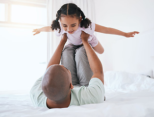 Image showing Airplane, playful and father with daughter in bedroom for morning, wake up and weekend. Happy, excited and funny with man and young girl playing in family home for happiness, freedom and support