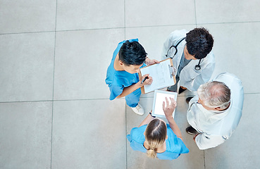 Image showing Healthcare, doctors and group meeting with a tablet for discussion, planning or research. Above men and women medical staff talking about team collaboration, online schedule or surgery in a hospital