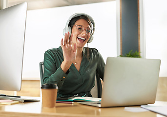 Image showing Virtual meeting, business woman smile and wave on a video call with headphones and greeting. Laptop, working and employee with webinar at a company with computer and digital communication at office