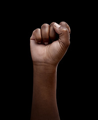 Image showing Human rights, protest and hand in fist for justice or solidarity, equality and support for a community. Fight for change, power. and revolution for freedom or empowerment on black or dark background
