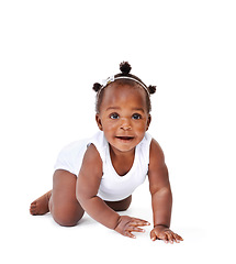 Image showing Smile, crawling and African girl baby isolated on white background with playful happiness and growth. Learning to crawl, playing and sitting, face of happy black kid on studio backdrop with childcare