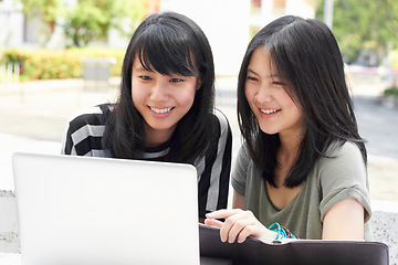 Image showing Smile, education and students with a laptop on campus for research, studying and project together. College, Asian and women reading an email on a computer, learning and happy with university work