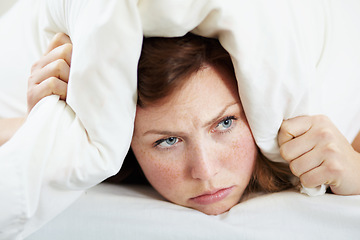 Image showing Insomnia, noise and woman with pillow on ears to block loud sound, sleep fail and tired on bed in bedroom. Stress, person and covering head with cushion for problem, tinnitus and frustrated at night.