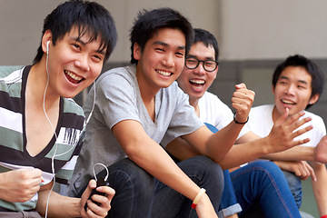 Image showing Asian men, students and outdoor celebration for success, goal or sports with smile, happiness and fist. Japanese student group, celebrate or friends for winning, achievement or sport event at campus