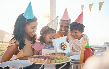 Image showing Birthday, surprise and family outdoors for party, celebration and present, happy and excited. Parents, children and gift for girl child at special event, wow and celebrating with food at restaurant