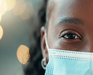 Image showing Zoom, doctor and face mask for black woman, hospital and safety from bacteria, germs and night for healthcare. African medic, nurse and dark clinic with macro, eye and portrait for wellness with ppe