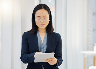 Image showing Office, tablet and Asian business woman typing workplace report, online project feedback or analysis of corporate data. Professional administration, reading and person working in Japanese company HQ