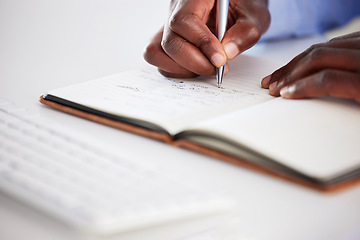 Image showing Closeup, hands writing and notebook in office for brainstorming, ideas and focus on career goals. African man, book and pen for schedule, administration or agenda with planning, journal and notes