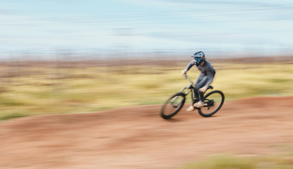 Image showing Sports, blur and man riding a bike in nature training for a race, marathon or competition. Fitness, motion and male athlete biker practicing for an outdoor cardio exercise, adventure or workout.