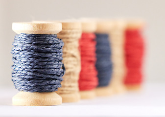 Image showing Rolls, color or fashion with string, sewing or material production against white studio background. Empty, knitting industry or texture with textiles, crocheting or weaving with embroidery or fabric