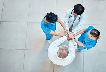 Image showing Healthcare, doctors and team with hands together in a hospital for support, trust and teamwork. Above men and women medical group or staff stacked for goal motivation, collaboration and solidarity