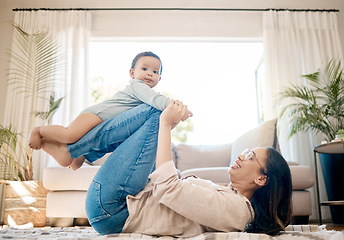 Image showing Home, love and mother play with baby for family bonding, quality time and child development together. New born, motherhood and happy mom carry infant for care, support and relationship in living room