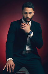 Image showing Young man, suit and studio portrait with business fashion, dark and mysterious aesthetic by red background. Businessman, formal and professional clothes with entrepreneurship, career and backdrop