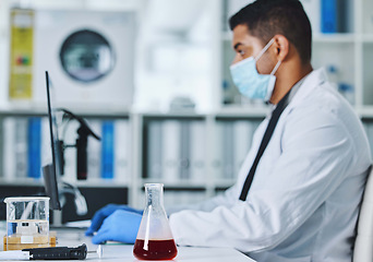 Image showing Scientist man, computer and typing in lab for medical, pharmaceutical or covid research in face mask. Young male doctor, innovation and report on pc, check dna and science app for blood in laboratory