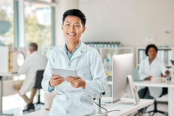 Image showing Asian man, tablet and portrait of a scientist in laboratory, hospital or research for medicine, chemistry or innovation. Doctor, technology and medical worker with smile in clinic or science lab