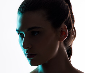 Image showing Beauty, neon and light with face of woman in studio for creative, glow and lighting mockup space. Fantasy, shadow and shine with female model on white background for art, disco and dark aesthetic