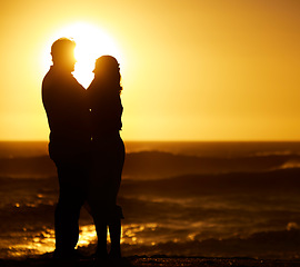 Image showing Silhouette, couple and hug at sunset on beach for vacation, holiday or mockup outdoor. Romantic man and woman in nature with creative sky, space and ocean for love, shadow art and travel or freedom