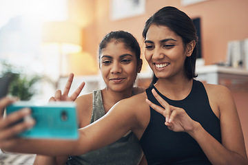 Image showing Peace sign, exercise selfie and women together at home for social media memory, emoji or post. Indian sisters or female friends taking photo for influencer update, fitness motivation or happy results