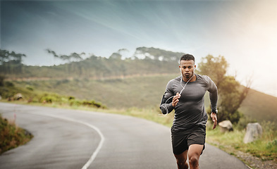 Image showing Man, road running and space in nature for exercise mockup, wellness or music with commitment for health. African male runner, listening and audio for focus, mindset and mock up with workout on street