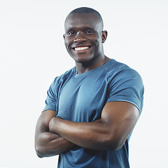 Image showing Black man, smile and portrait with strong arms crossed and confidence in a studio. White background, African male person and happy model face with pride, active style and fitness fashion isolated