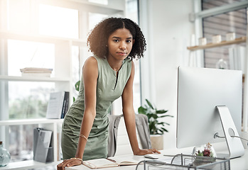 Image showing Computer, portrait and serious business woman working by her desk or table in a corporate startup company. Internet, online and young professional female employee or planner in an agency office