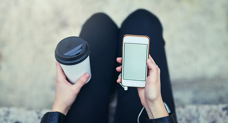 Image showing Top view mockup, hands and phone screen with coffee in city, internet scroll and social media outdoor. Cellphone, space and hand of woman with marketing, advertising or commercial promotion in street