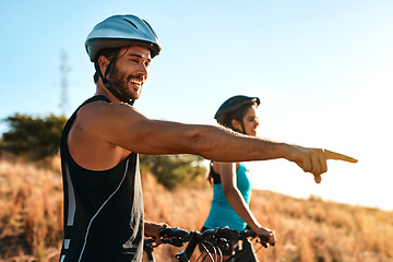 Image showing Happy couple, pointing and cycling in the mountains for fitness and exercise together. Bike, wellness and young man with woman outdoor for adventure, sports or happiness of freedom on blue sky mockup