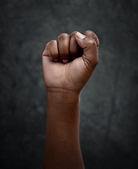 Image showing Equality, protest and hand fist for justice or solidarity, human rights and support for the community. Fight for change, power. and revolution for freedom or empowerment on dark or black background