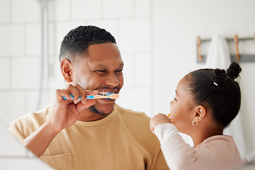 Image showing Father, child and brushing teeth in a family home bathroom for dental health and wellness in a mirror. Happy african man and girl kid learning to clean mouth with a toothbrush for oral hygiene