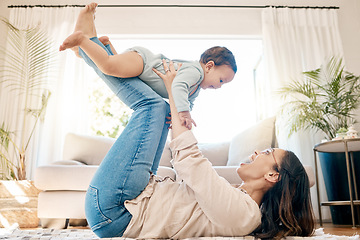 Image showing Play, love and mother lift baby for bonding, quality time and child development together in family home. New born, motherhood and happy mom with infant for care, support and playing in living room